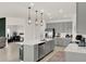 Bright kitchen with stainless steel appliances, island with sink, and ample cabinet space at 4180 Bull St, St Cloud, FL 34772