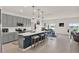 Open-concept kitchen with an island, stainless steel appliances, and adjacent dining area at 4180 Bull St, St Cloud, FL 34772