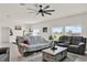 Bright living room with a ceiling fan, large windows, and comfortable seating at 4180 Bull St, St Cloud, FL 34772