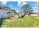Spacious backyard featuring a well-kept lawn and storage shed, perfect for outdoor activities and storage at 449 Martigues Drive, Kissimmee, FL 34759