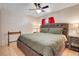 Bedroom featuring a large, tufted bed and neutral decor at 449 Martigues Drive, Kissimmee, FL 34759