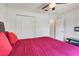 Bedroom featuring a closet, neutral walls, ceiling fan, and red bedding at 449 Martigues Drive, Kissimmee, FL 34759