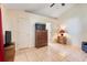 Bedroom with tile flooring, door to bathroom, dresser, and ample natural light at 449 Martigues Drive, Kissimmee, FL 34759