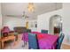 Dining area featuring tile flooring, a chandelier, views to the living room, and arched doorways at 449 Martigues Drive, Kissimmee, FL 34759