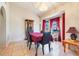 Dining area with a large window, chandelier, and dark wood furniture at 449 Martigues Drive, Kissimmee, FL 34759