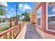 Side exterior view of a charming home featuring a fountain, decorative flower beds and an outdoor patio at 449 Martigues Drive, Kissimmee, FL 34759