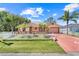 Charming single-Gathering home with well-manicured lawn, fountain, palms, and a white picket fence at 449 Martigues Drive, Kissimmee, FL 34759