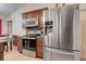 Kitchen with stainless steel appliances, brown cabinets and tile flooring at 449 Martigues Drive, Kissimmee, FL 34759