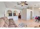 Open floor plan living room with tile flooring, neutral walls, and views of the kitchen at 449 Martigues Drive, Kissimmee, FL 34759