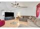 Cozy living room with comfortable seating, tile floors, and an entertainment center at 449 Martigues Drive, Kissimmee, FL 34759