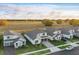 Aerial view of several two-story homes, showcasing their layout and green surroundings under a blue sky at 4778 Cragmere Loop, Clermont, FL 34711