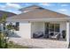 Backyard with covered patio and pavers and a beautiful lawn at 4778 Cragmere Loop, Clermont, FL 34711