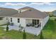 Backyard with covered patio and pavers and a beautiful lawn at 4778 Cragmere Loop, Clermont, FL 34711