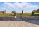 Backyard featuring brick pavers, retaining wall, and lush landscaping at 4778 Cragmere Loop, Clermont, FL 34711