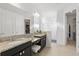 Modern bathroom featuring double sinks, granite countertops, and a glass enclosed shower at 4778 Cragmere Loop, Clermont, FL 34711