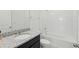 Bathroom featuring granite vanity top and tiled shower and tub at 4778 Cragmere Loop, Clermont, FL 34711