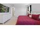 Comfortable bedroom with large TV, white dresser, and bright white walls for a clean and relaxing ambiance at 4778 Cragmere Loop, Clermont, FL 34711