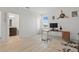 Bonus room featuring wood flooring, airplane propeller decor, desk, and accent wall at 4778 Cragmere Loop, Clermont, FL 34711