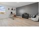 Bonus room featuring wood flooring, airplane propeller decor, desk, and accent wall at 4778 Cragmere Loop, Clermont, FL 34711