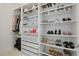 Walk-in closet with custom shelving for shoe and clothing storage at 4778 Cragmere Loop, Clermont, FL 34711