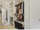 Walk-in closet with custom shelving for shoe and clothing storage at 4778 Cragmere Loop, Clermont, FL 34711