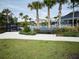 Relaxing community pool area with palm trees, bench, and manicured landscaping offers a serene outdoor retreat at 4778 Cragmere Loop, Clermont, FL 34711