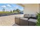 Covered patio with outdoor sofas overlooking landscaped backyard at 4778 Cragmere Loop, Clermont, FL 34711