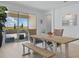 Bright dining room featuring a farmhouse table and bench, with sliding glass doors to the outdoor patio at 4778 Cragmere Loop, Clermont, FL 34711