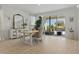 Bright dining room featuring a farmhouse table and bench, with sliding glass doors to the outdoor patio at 4778 Cragmere Loop, Clermont, FL 34711