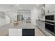Modern kitchen with granite countertops, stainless steel appliances, and white cabinets at 4778 Cragmere Loop, Clermont, FL 34711