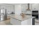Bright kitchen with granite countertops, stainless steel appliances, and a large center island at 4778 Cragmere Loop, Clermont, FL 34711