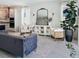 Open-concept living room boasts stylish decor, modern furniture, large mirror, and an inviting atmosphere at 4778 Cragmere Loop, Clermont, FL 34711