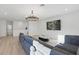 Open-concept living room features modern finishes, ample natural light, and luxury vinyl flooring at 4778 Cragmere Loop, Clermont, FL 34711