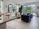 Bright living room with slider doors to patio, elegant decor, stylish furniture, and lots of natural light at 4778 Cragmere Loop, Clermont, FL 34711