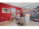 Bright home office with large colorful mural wall, modern desk, and large window at 4778 Cragmere Loop, Clermont, FL 34711