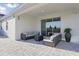 Relaxing outdoor patio space with comfortable seating and sliding glass doors to indoor living at 4778 Cragmere Loop, Clermont, FL 34711