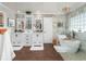 Beautiful bathroom featuring double vanities, soaking tub with shower, and decorative tile detail at 5011 Dorian Ave, Belle Isle, FL 32812