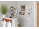 Tastefully decorated bathroom, featuring stylish shelves, potted plants, towels, and warm brown accents at 5011 Dorian Ave, Belle Isle, FL 32812
