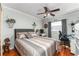 This cozy bedroom features stylish decor and hardwood floors, creating a serene retreat at 5011 Dorian Ave, Belle Isle, FL 32812