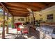 Spacious covered patio with comfortable seating, grill, and fan, ideal for outdoor dining and gatherings at 5011 Dorian Ave, Belle Isle, FL 32812