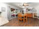 A dining area with wood floors features a glass table, wood chairs, and a patio with sliding glass doors at 5011 Dorian Ave, Belle Isle, FL 32812