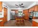 A charming kitchen features wood floors, stainless appliances, wood cabinets and a center island with seating at 5011 Dorian Ave, Belle Isle, FL 32812