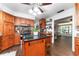 Open concept kitchen features granite countertops, wood floors and cabinets, and stainless steel appliances at 5011 Dorian Ave, Belle Isle, FL 32812
