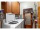 Functional laundry room with washer, dryer, storage cabinets, and convenient outdoor access at 5011 Dorian Ave, Belle Isle, FL 32812