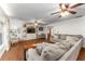 Bright, expansive living room with hardwood floors, neutral walls, and built-in media center at 5011 Dorian Ave, Belle Isle, FL 32812