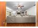 Spacious living room with an extra-large sofa, hardwood floors, and built-in shelving at 5011 Dorian Ave, Belle Isle, FL 32812