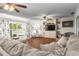 Open living room showcasing hardwood floors, neutral walls, and views into the kitchen at 5011 Dorian Ave, Belle Isle, FL 32812