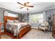 Inviting main bedroom featuring a large window, hardwood floors, and neutral decor at 5011 Dorian Ave, Belle Isle, FL 32812