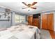 Comfortable main bedroom with a ceiling fan, warm hardwood floors, and a cozy quilt on the bed at 5011 Dorian Ave, Belle Isle, FL 32812