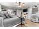 Serene primary bedroom with a gray color palette, dresser, and a TV for ultimate relaxation at 5011 Dorian Ave, Belle Isle, FL 32812